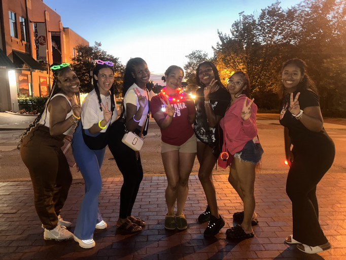 students posing with glowsticks